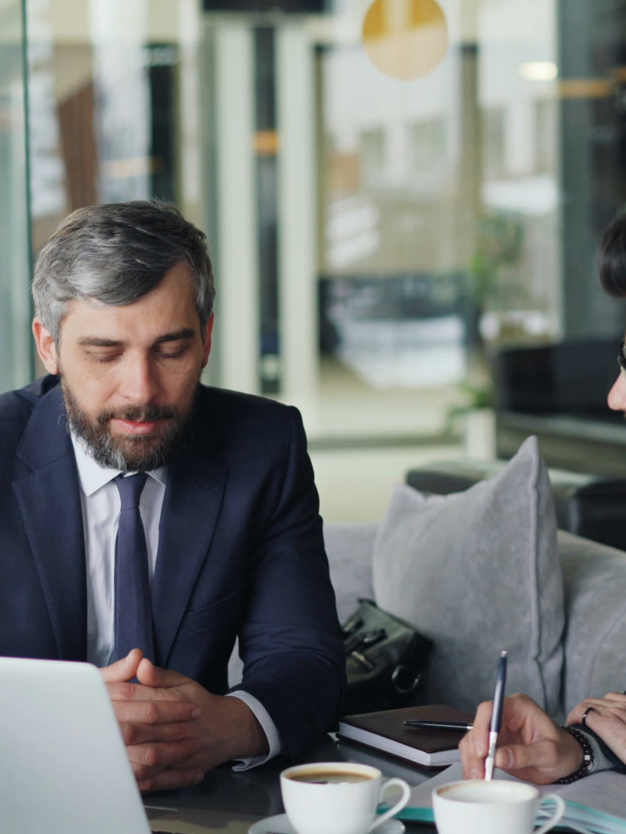 Two business owners reviewing strategy together over coffee
